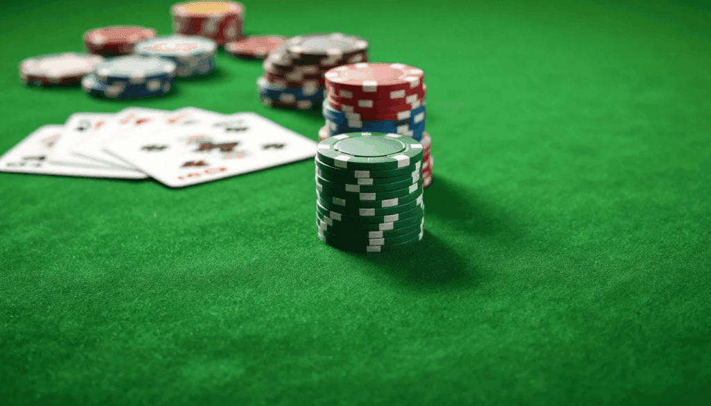 A close-up view of a casino gaming table showcases an array of colorful chips and playing cards, inviting players to engage in popular casino games. This image reflects the vibrant atmosphere of usa casinos, where players can enjoy thrilling experiences and generous bonuses.